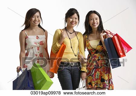 Three women holding shopping bags. View Large Photo Image Stock Photo - Three women holding shopping bags.. Fotosearch