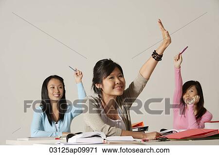 Three women raising their hands in class. View Large Photo Image Stock Image - Three women raising their hands in class.. Fotosearch