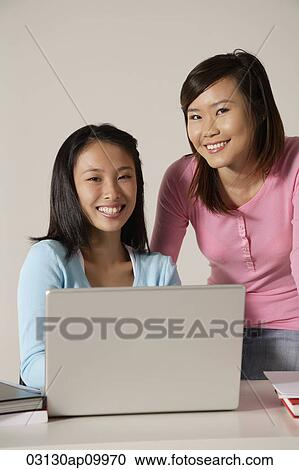 Two women at laptop, smiling. View Large Photo Image Stock Image - Two women at laptop, smiling.. Fotosearch