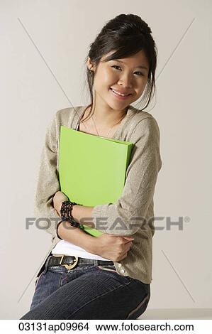 Picture - young woman holding a folder.. Fotosearch
