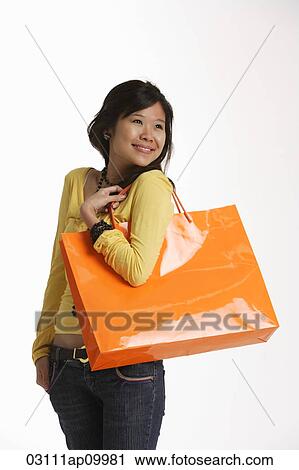 Young woman holding large shopping bag. View Large Photo Image Stock Image - Young woman holding large shopping bag.. Fotosearch