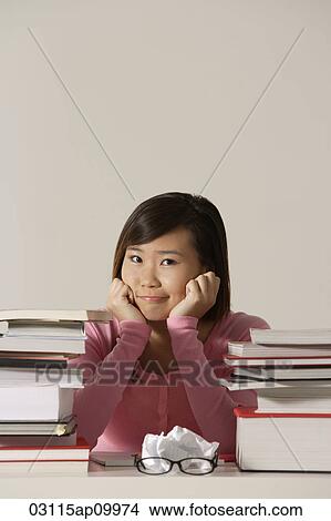 young woman sitting at desk. View Large Photo Image Picture - young woman sitting at desk.. Fotosearch
