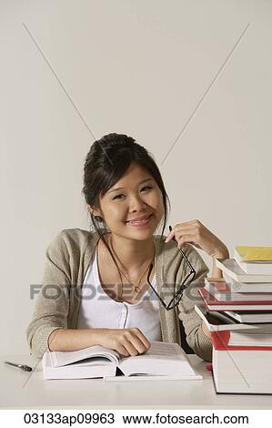 Stock Image - young woman studying. Fotosearch