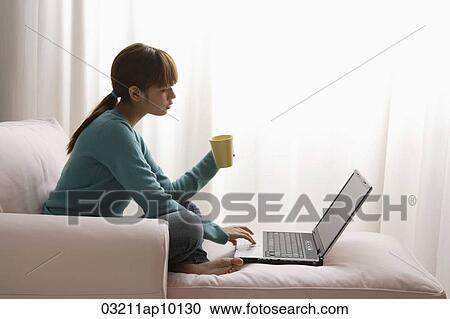 Asian girl at home on laptop View Large Photo Image Stock Image - Asian girl at home on laptop. Fotosearch