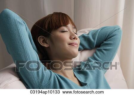 Asian girl relaxing with eyes closed View Large Photo Image Stock Image - Asian girl relaxing with eyes closed. Fotosearch