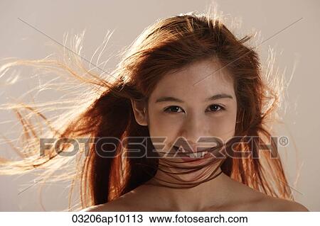 Asian girl with wind blown hair View Large Photo Image Stock Image - Asian girl with wind blown hair. Fotosearch