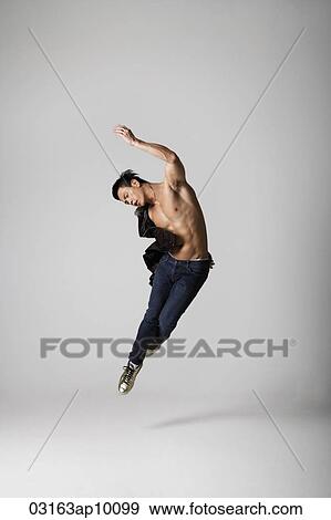 Bare chested man jumping gracefully View Large Photo Image Stock Photo - Bare chested man jumping gracefully. Fotosearch