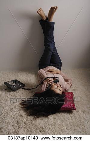 Chinese woman laying on floor, talking on phone View Large Photo Image Stock Image - Chinese woman laying on floor, talking on phone. Fotosearch