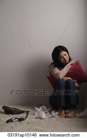 Chinese woman sitting on floor looking sad View Large Photo Image Stock Photograph - Chinese woman sitting on floor looking sad. Fotosearch