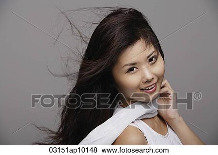 Chinese woman wearing white, hair blowing View Large Photo Image Stock Photo - Chinese woman wearing white, hair blowing. Fotosearch
