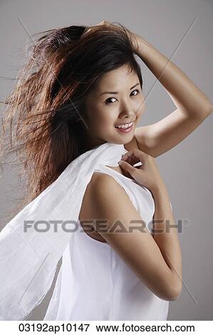 Chinese woman wearing white, hair blowing View Large Photo Image Stock Photo - Chinese woman wearing white, hair blowing. Fotosearch