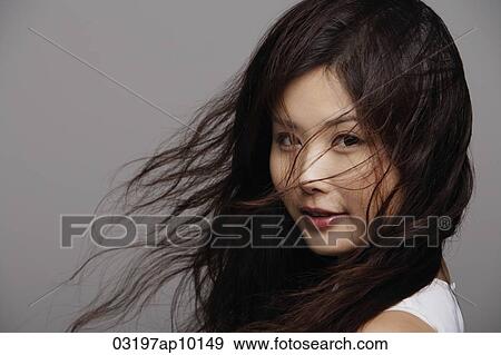 Head shot of Chinese woman with wind blown hair View Large Photo Image Stock Photo - Head shot of Chinese woman with wind blown hair. Fotosearch