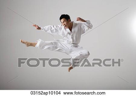 Man doing a flying kick, martial arts View Large Photo Image Picture - Man doing a flying kick, martial arts. Fotosearch