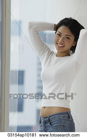 Young Asian woman holding up hair View Large Photo Image Stock Image - Young Asian woman holding up hair. Fotosearch