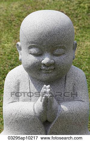 Close up of Buddhist statue praying View Large Photo Image Stock Photo - Close up of Buddhist statue praying. Fotosearch