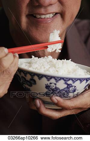 cropped shot of mature man holding chopsticks and bowl of rice View Large Photo Image Stock Photograph - cropped shot of mature man holding chopsticks and bowl of rice. Fotosearch