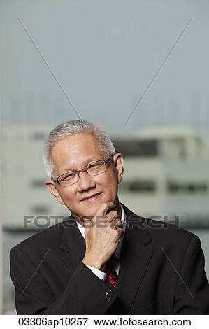 Stock Photo - head shot of mature man with grey hair. Fotosearch
