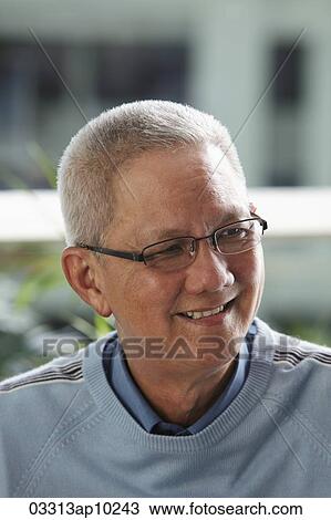 Stock Image - head shot of mature man with silver hair smiling. Fotosearch