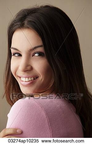 head shot of young woman looking over her shoulder View Large Photo Image Stock Photography - head shot of young woman looking over her shoulder. Fotosearch