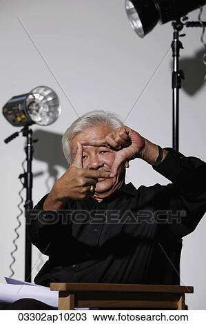 Mature Chinese man framing a shot with fingers View Large Photo Image Stock Image - Mature Chinese man framing a shot with fingers. Fotosearch