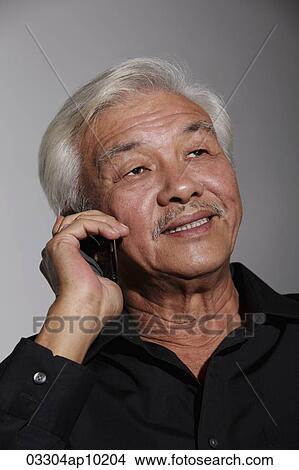Mature Chinese man talking on phone View Large Photo Image Picture - Mature Chinese man talking on phone. Fotosearch