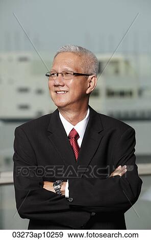 mature man wearing a suit smiling with arms crossed View Large Photo Image Stock Photo - mature man wearing a suit smiling with arms crossed. Fotosearch