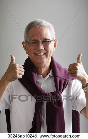 mature man with grey hair holding thumbs up and smiling View Large Photo Image Stock Photography - mature man with grey hair holding thumbs up and smiling. Fotosearch