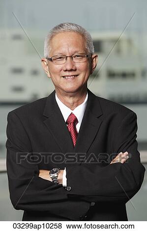 Stock Photo - mature man with grey hair wearing a suit and smiling. Fotosearch