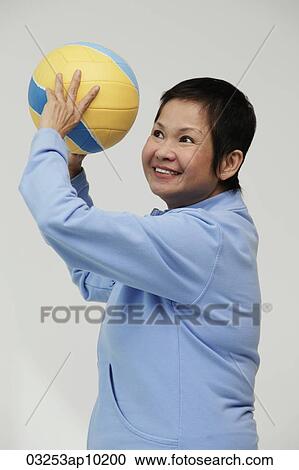 Mature woman throwing a volleyball View Large Photo Image Stock Image - Mature woman throwing a volleyball. Fotosearch