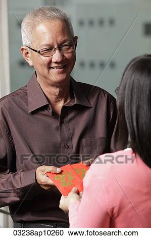 older man passing red envelopes "hong bao" to woman View Large Photo Image Stock Image - older man passing red envelopes "hong bao" to woman. Fotosearch