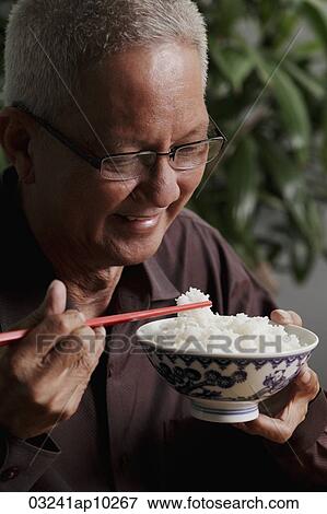profile of mature man holding chopsticks and bowl of rice View Large Photo Image Stock Photo - profile of mature man holding chopsticks and bowl of rice. Fotosearch