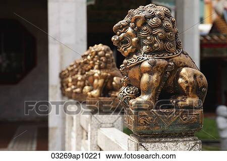 Row of bronze statues in front of Buddhist temple. View Large Photo Image Stock Image - Row of bronze statues in front of Buddhist temple.. Fotosearch