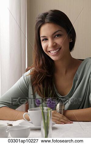 young woman at a cafe, smiling looking at camera View Large Photo Image Stock Photo - young woman at a cafe, smiling looking at camera. Fotosearch