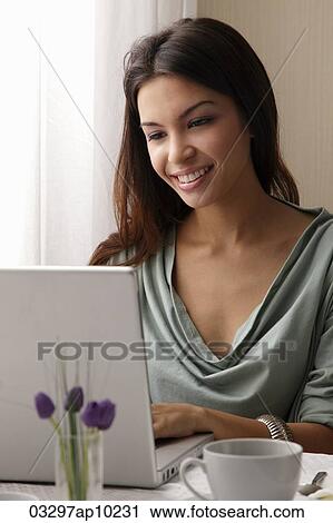 young woman working on laptop View Large Photo Image Stock Image - young woman working on laptop. Fotosearch