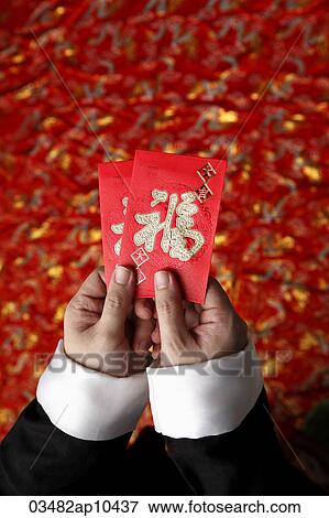 Cropped shot of hands holding red envelopes View Large Photo Image Stock Photo - Cropped shot of hands holding red envelopes. Fotosearch