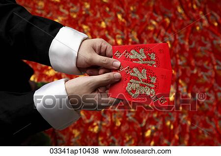 Cropped shot of man holding lucky Hong Bao, red envelope View Large Photo Image Stock Photo - Cropped shot of man holding lucky Hong Bao, red envelope. Fotosearch