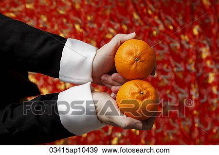 Hands holding 2 oranges. View Large Photo Image Stock Photo - Hands holding 2 oranges.. Fotosearch