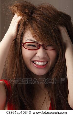 Head shot of woman wearing glasses and messing up her hair and smiling View Large Photo Image Stock Image - Head shot of woman wearing glasses and messing up her hair and smiling. Fotosearch