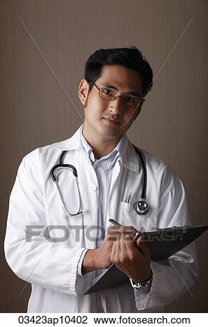 Male doctor holding clip board View Large Photo Image Stock Image - Male doctor holding clip board. Fotosearch