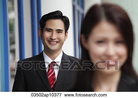 man smiling with woman in out of focus in foreground View Large Photo Image Stock Photo - man smiling with woman in out of focus in foreground. Fotosearch