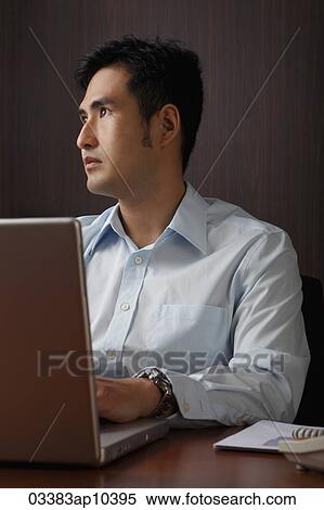 man working on lap top looking up View Large Photo Image Stock Photography - man working on lap top looking up. Fotosearch