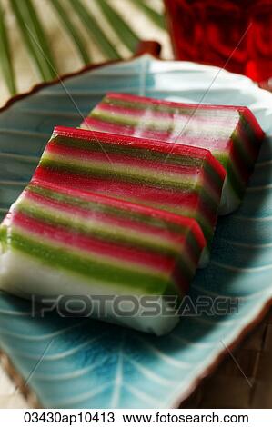 Stock Image - Nine layer cake (Kueh) on a plate. Traditional Malay dessert.. Fotosearch