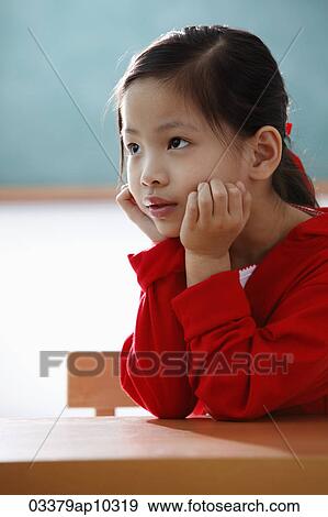 Portrait of young girl with hands on her face looking up View Large Photo Image Stock Photo - Portrait of young girl with hands on her face looking up. Fotosearch