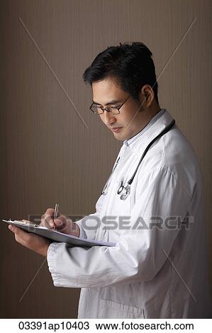 Profile of male doctor holding clipboard View Large Photo Image Stock Image - Profile of male doctor holding clipboard. Fotosearch