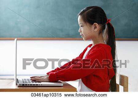 Profile of young girl looking at the computer View Large Photo Image Stock Photography - Profile of young girl looking at the computer. Fotosearch