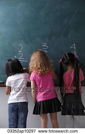 three girls writing on chalk view View Large Photo Image Stock Photo - three girls writing on chalk view. Fotosearch