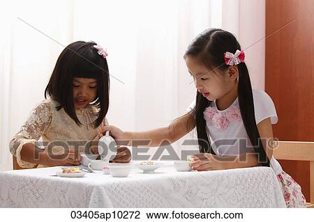 two little girls having a tea party View Large Photo Image Stock Image - two little girls having a tea party. Fotosearch