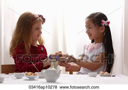 Stock Photo - two young girls having a tea party. Fotosearch