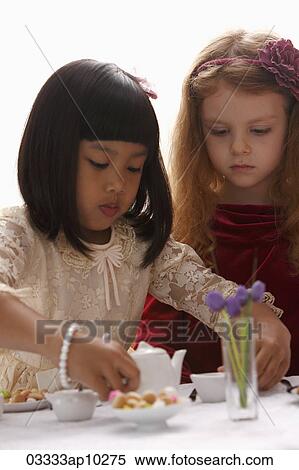 two young girls having a tea party View Large Photo Image Stock Photography - two young girls having a tea party. Fotosearch