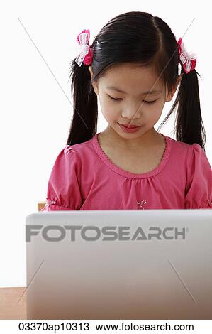 Young Chinese girl looking at laptop View Large Photo Image Stock Image - Young Chinese girl looking at laptop. Fotosearch